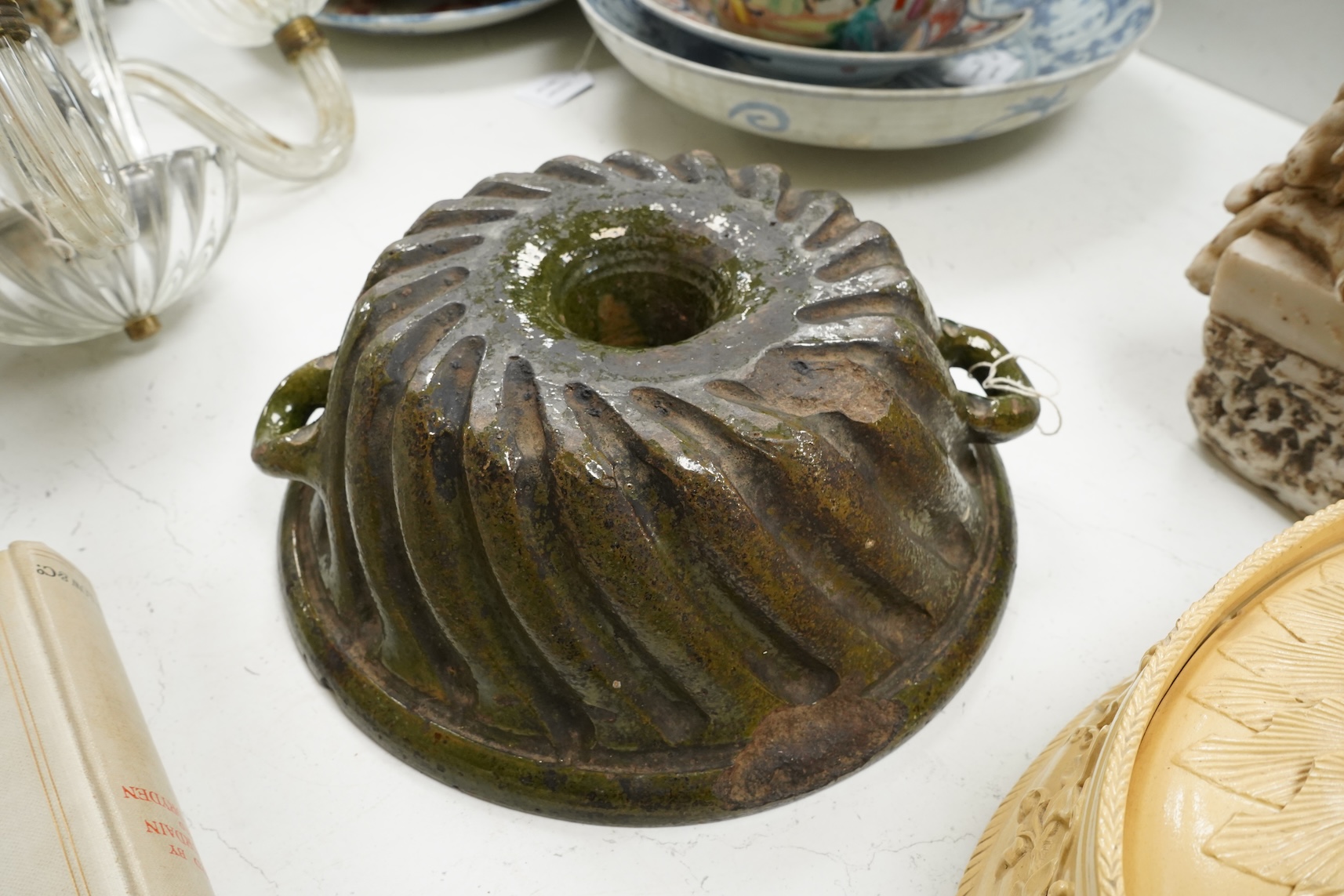 A 19th century oval caneware game/pie dish and cover, 24cm wide with an antique cake mould, (2)